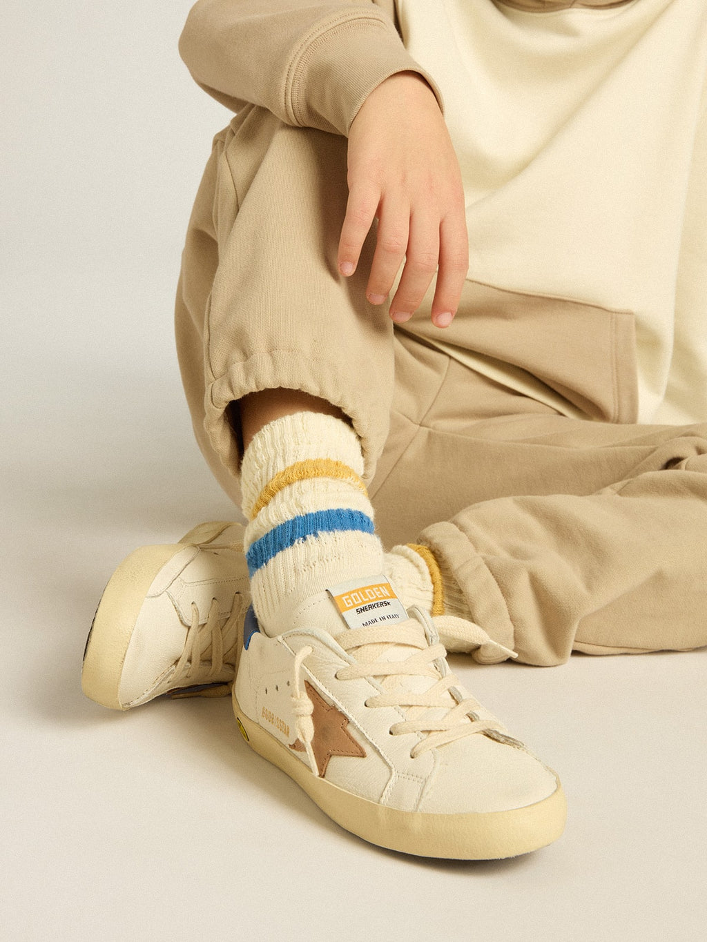 Worn white Kids socks with distressed details and two-tone bright blue and mustard stripes| Golden Goose