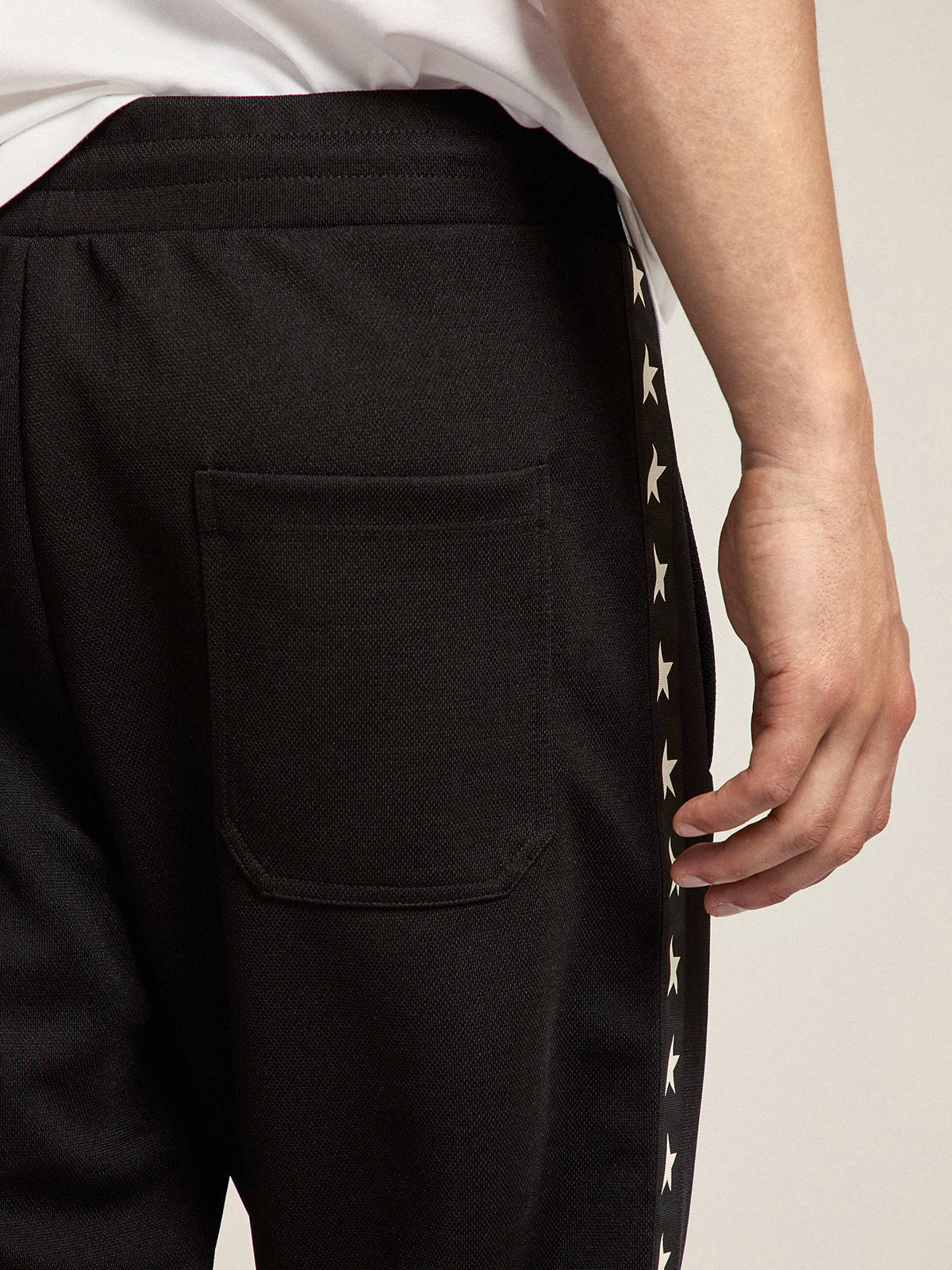 Men's black joggers with white stars on the sides| Golden Goose