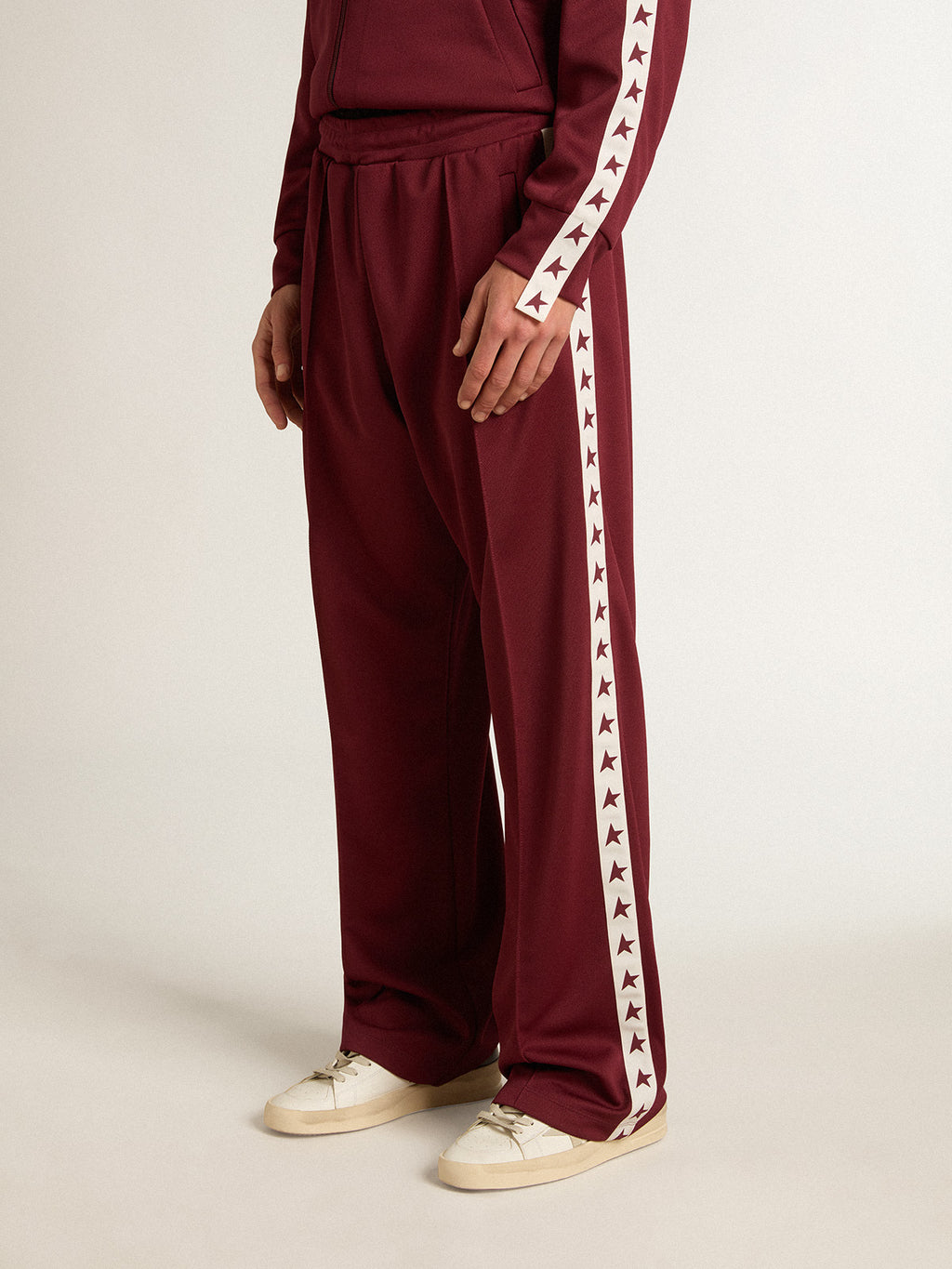 Men's burgundy joggers with stars on the sides| Golden Goose