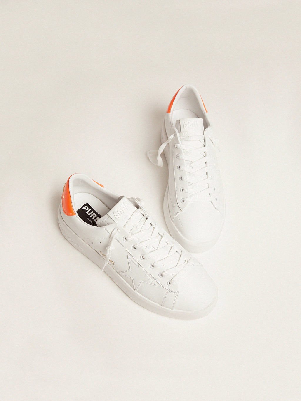 White Purestar sneakers with fluorescent orange heel tab| Golden Goose