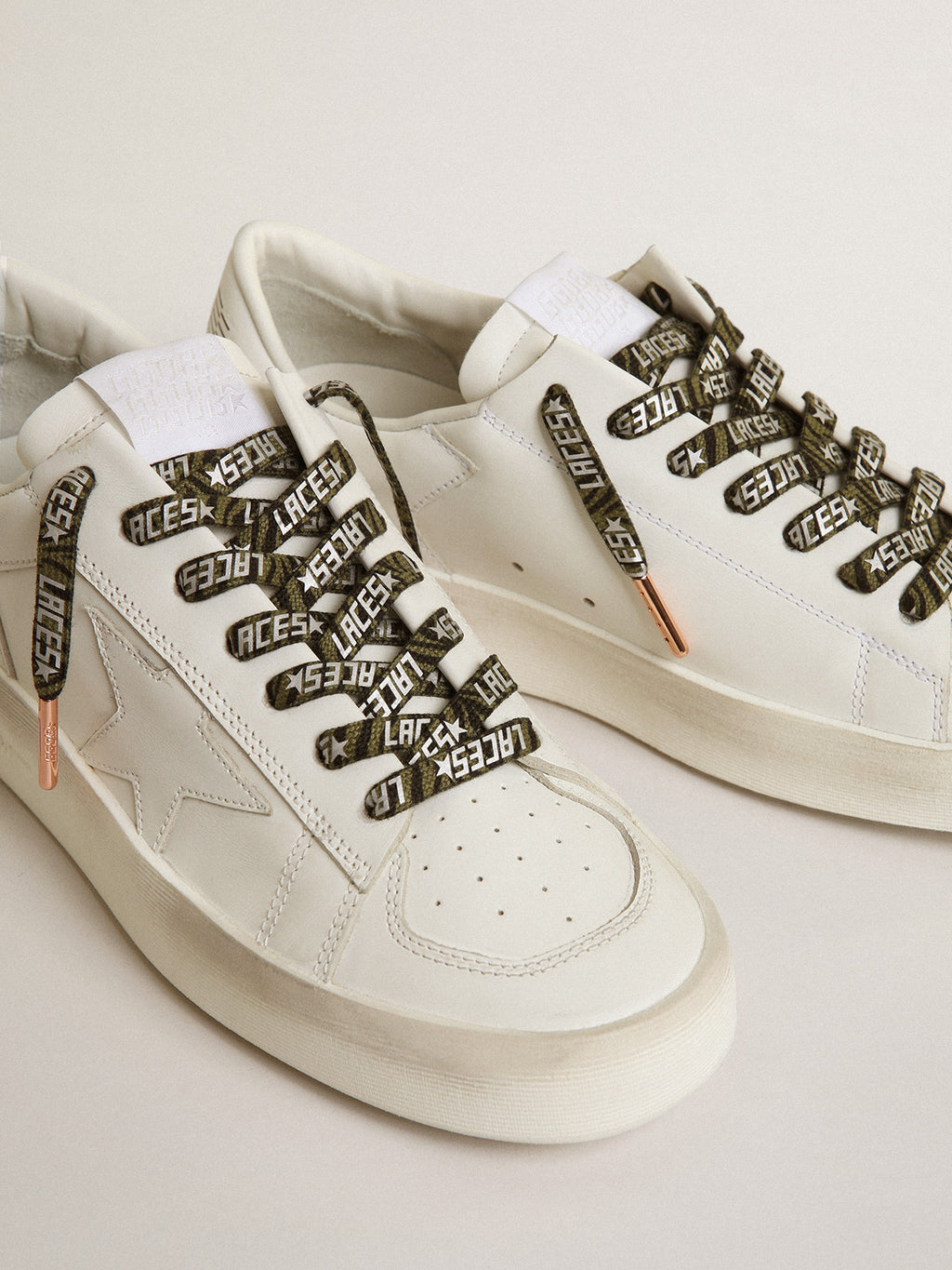 Green and black zebra-print laces with contrasting silver-colored 'Laces' lettering| Golden Goose