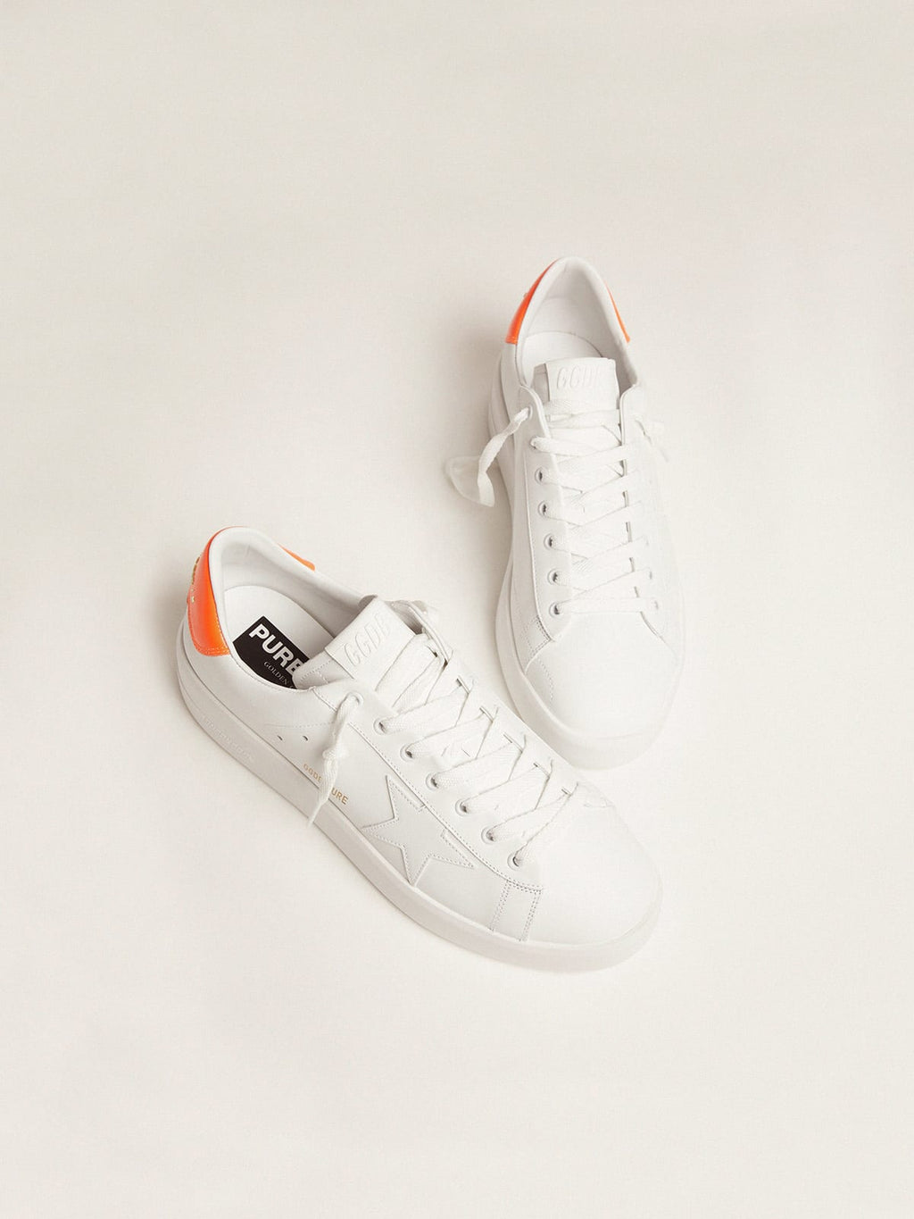 White Purestar sneakers with fluorescent orange heel tab| Golden Goose