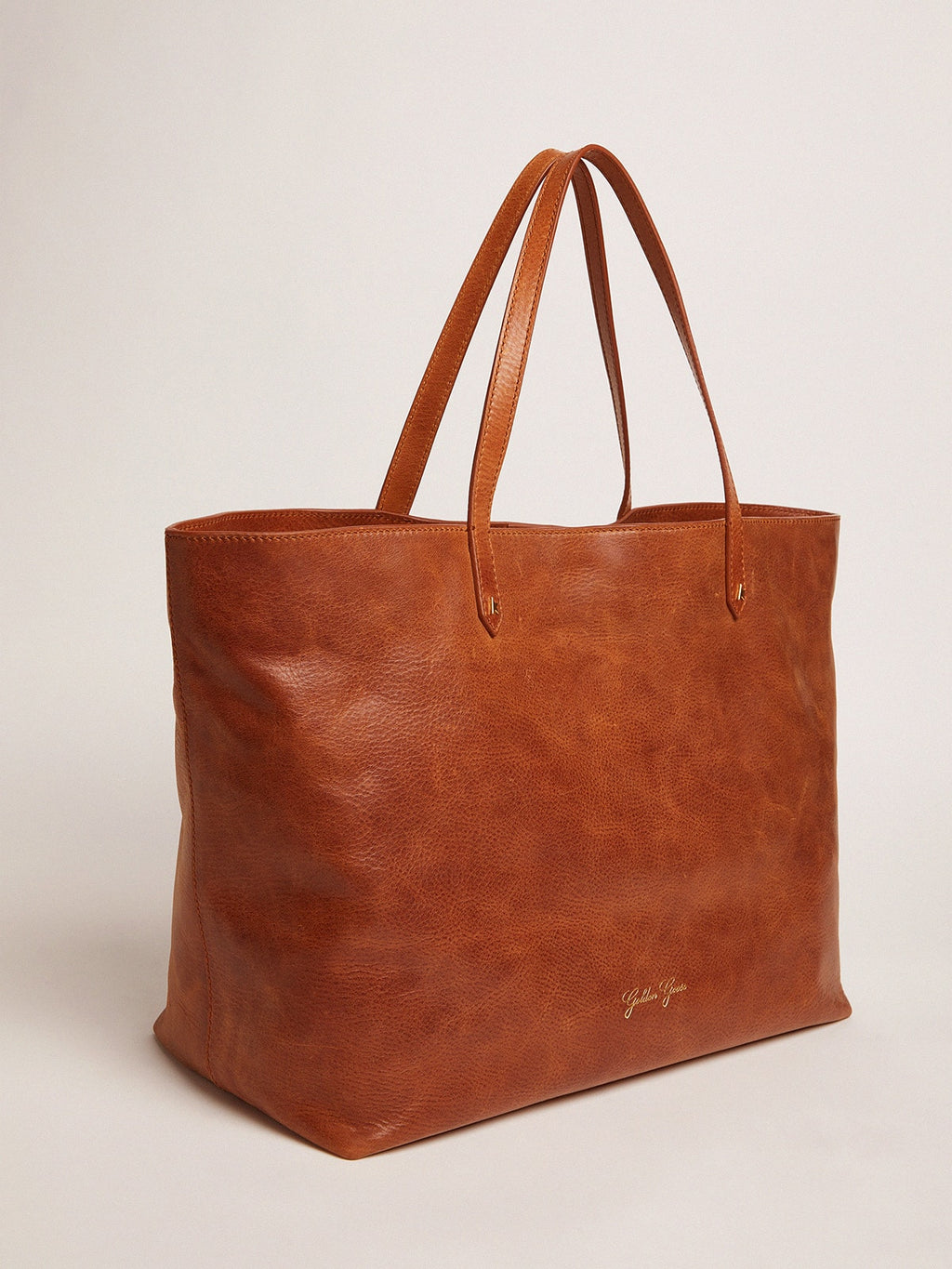 Pasadena Bag in tan-colored glossy hammered leather with gold logo on the front| Golden Goose